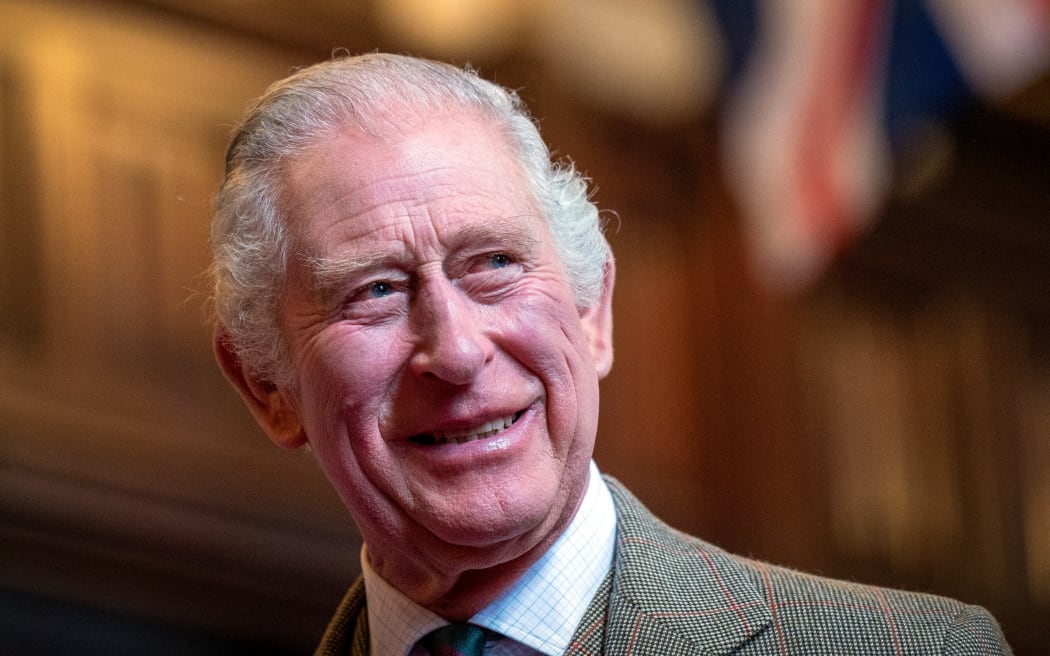 Britain's King Charles III reacts as he meets with families from Afghanistan, Syria and Ukraine who have settled in Aberdeen, during a visit to Aberdeen Town House, on October 17, 2022. (Photo by Jane Barlow / POOL / AFP)
