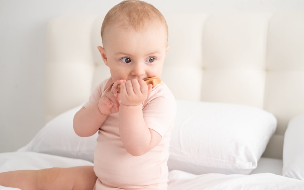 Baby with teething toy