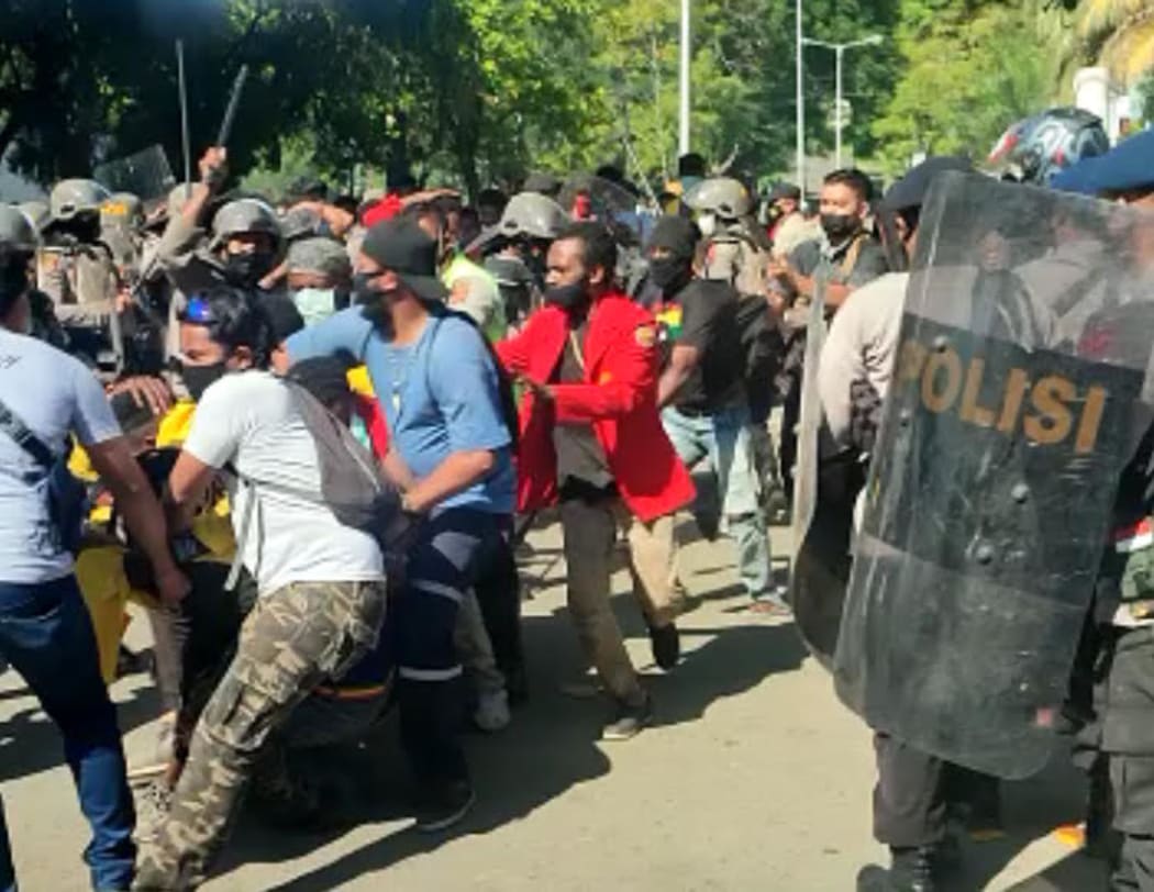 Indonesian police move in on a demonstration by West Papuan university student against the government's plans for the administration of their region, Jayapura, 14 July 2021.