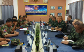 Commanders of the Royal Thai Army (R) and Royal Cambodian Army (L) meet at the Thai-Cambodia border.