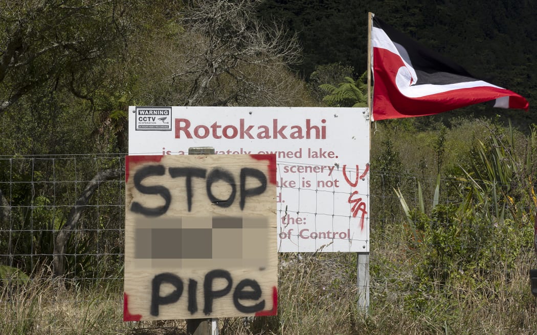 Signs as part of a protest at Rotorua's Lake Rotokākahi, on 31 January, 2024.