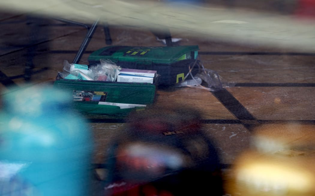 A photograph taken on August 12, 2024 shows a first aid kit on the floor of the TWG Tea shop in Leicester square, London. A woman and an 11-year-old girl were hospitalised on August 12 after being stabbed in central London's famous Leicester Square, police said, adding that a man had been arrested. (Photo by BENJAMIN CREMEL / AFP)