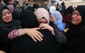 Mourners are reacting next to the bodies of Palestinians killed in Israeli strikes on the al-Maghazi refugee camp, amid the ongoing conflict between Israel and Hamas, at Al-Aqsa hospital in Deir Balah in the central Gaza Strip, on 25 December, 2023.