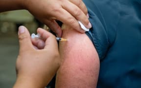 A worker on the frontline of Auckland's Jet Park Hotel quarantine facility being vaccinated against Covid-19 on 20 February 2021.
