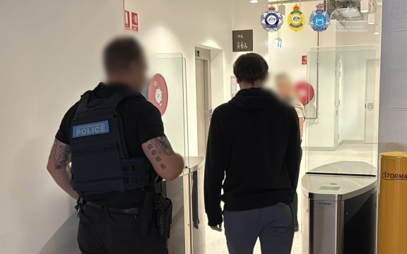 Australian police have charged a New Zealand man over alleged violent extremist material.