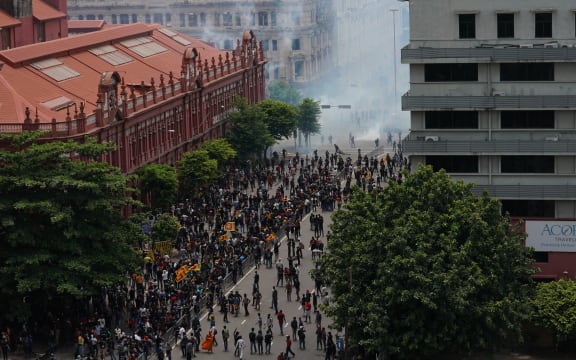 Security forces fire tear gas to disperse an anti-government protest rally outside the president's official residence on 9 July, 2022, in Colombo, Sri Lanka.