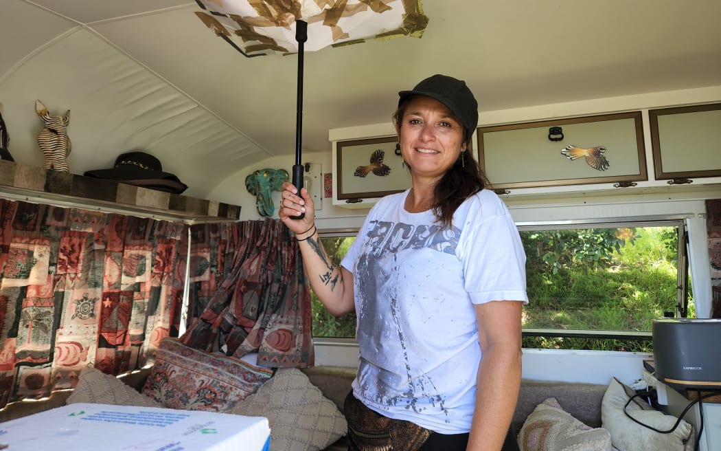Muriwai resident Teena Stevens says their caravan has survived a summer of successive weather events and is still holding out strong, with a blunt umbrella plugging a hole in the roof.