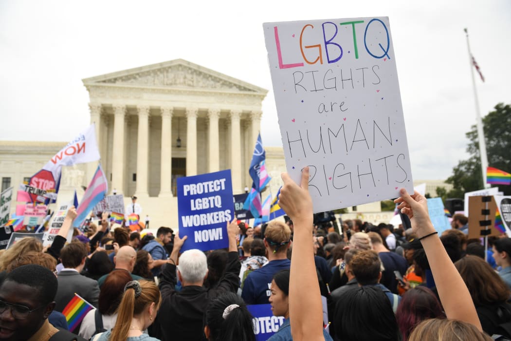 Demonstrators in favour of LGBT rights rally outside the US Supreme Court in Washington, DC, October 8, 2019, as the Court holds oral arguments in three cases dealing with workplace discrimination based on sexual orientation. (Photo by SAUL LOEB / AFP)