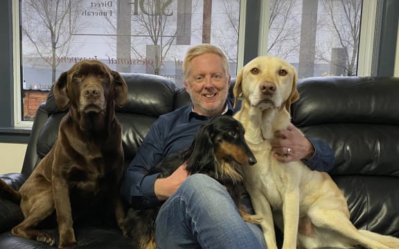 Owen Haring doesn’t think it’s justifiable to have to pay that much to have chocolate labrador Holly, dachshund Frankie, and golden labrador Harry at his home. Photo: Max Frethey.