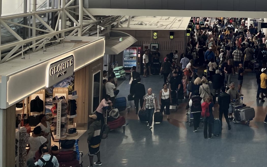 Crowds at Auckland Airport as travelers head away for Christmas 2024.