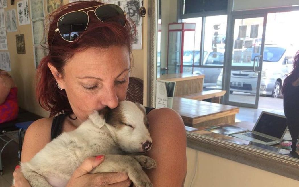 Angela Glover with a rescued puppy.
