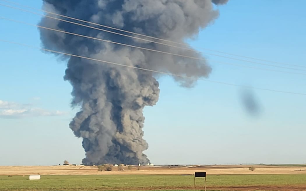 Smoke rises from the scene of South Fork Dairy near Dimmit, Texas.
