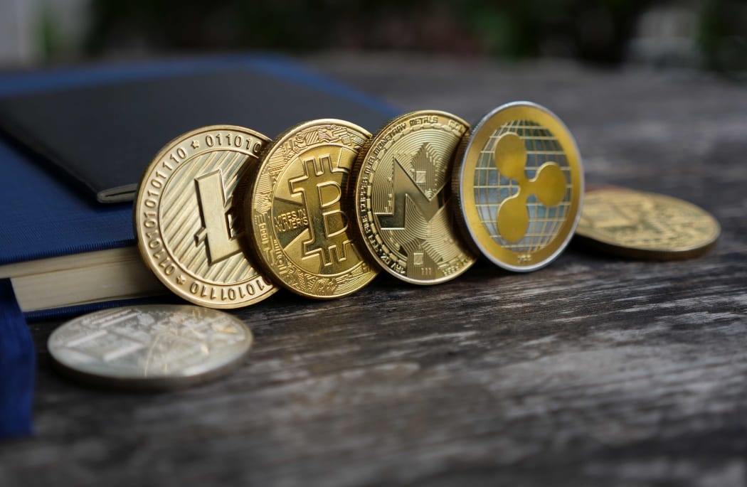 bitcoin onecoin ripple on wooden background and copy space, cryptocurrency money exchange investment concept.