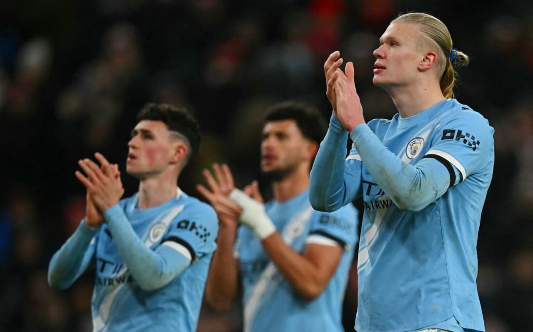 Manchester City's Norwegian striker Erling Haaland applauds the fans.