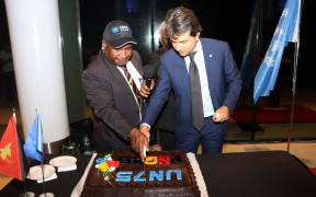 Papua New Guinea Prime Minister James Marape and the United Nations' Resident Co-ordinator Gianluca Rampolla cut cake at a Partnership Dialogue in Port Moresby to mark 75 years of existence of the UN, 3 November 2020.