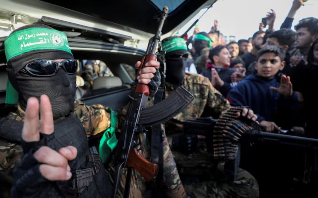 Hamas militants parade through Gaza after the ceasefire with Israel began on Sunday.