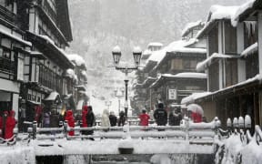 Snow covers Ginzan Onsen, a hot spring resort in Obanazawa, Yamagata Prefecture, northeastern Japan, on 23 December 2024.