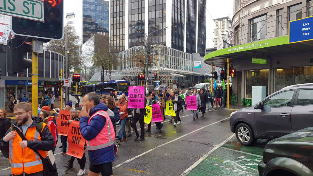 Protesters march to the Austrian oil giant OMV's Majestic Centre headquarters in Wellington.