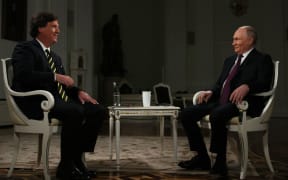 In this pool photograph distributed by Russian state agency Sputnik, Russia's President Vladimir Putin gives an interview to US talk show host Tucker Carlson at the Kremlin in Moscow on February 6, 2024. (Photo by Gavriil GRIGOROV / POOL / AFP)