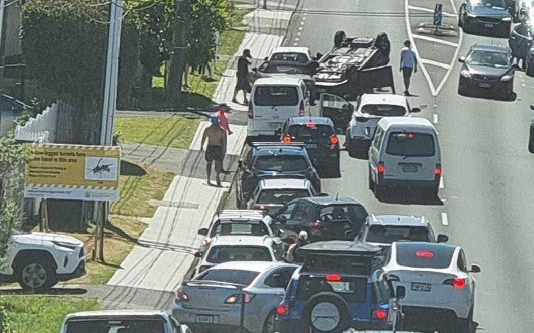 A car flips on Waipa St on Auckland's North Shore