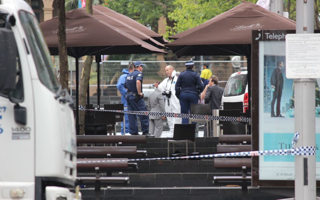 Police and forensics officers outside the Lindt Chocolate Cafe in Martin Place on December 16, 2014, where three people died in a violent siege including the gunman Man Haron Monis.