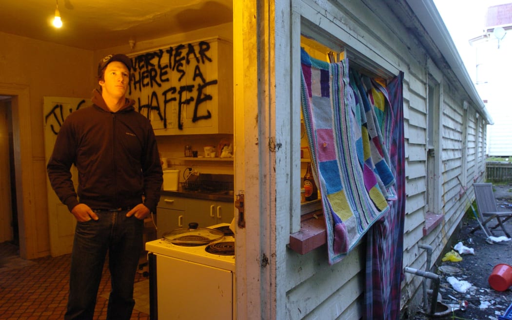 Third-year University of Otago student Sam Uffindell in the kitchen of his environmentally hazardous Dundas St flat. The drain visible outside the back door previously poured toilet waste into the back yard.