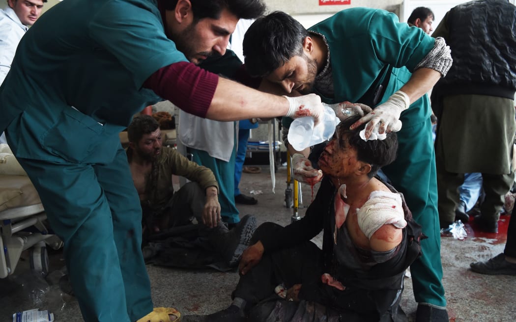 Afghan medical staff treat a wounded man after a car bomb exploded near the old Interior Ministry building, at Jamhuriat Hospital in Kabul. January 27, 2018.
