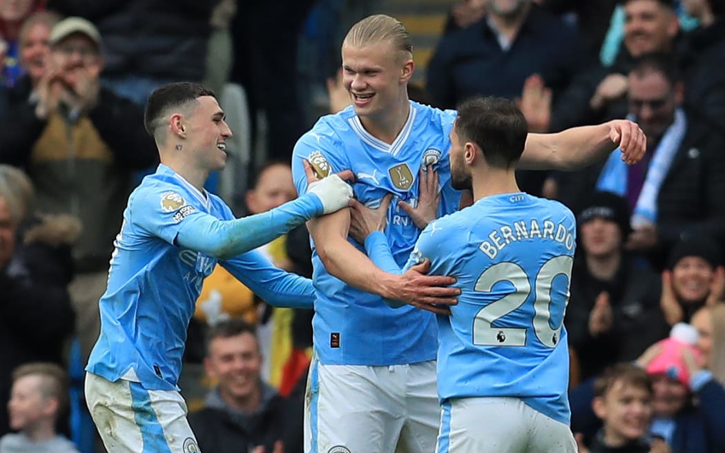 Erling Haaland celebrates with his Manchester City team-mates.