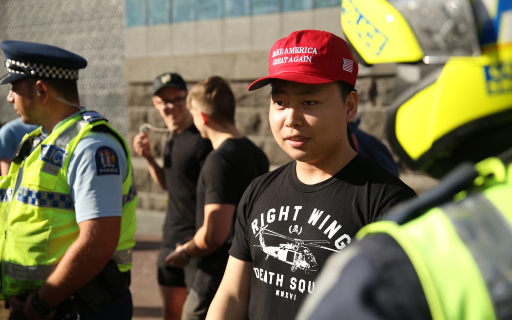 This man, one of about six Trump supporters at the anti-Trump rally, chose to wear a 'right wind death squad' t shirt.