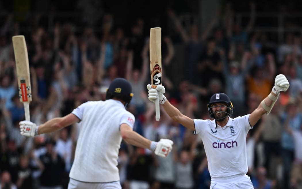 England's Mark Wood, right, celebrates with England's Chris Woakes after Woakes hits a boundary to win the test match on day four of the third Ashes cricket Test match between England and Australia at Headingley cricket ground in Leeds, England on July 9, 2023.