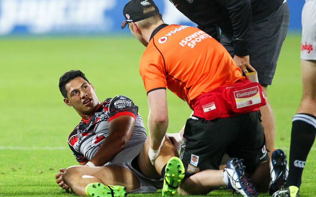 Roger Tuivasa-Sheck receives treatment for his injured knee during the Warriors match against the Bulldogs in Wellington.
