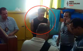 Phillip John Smith being taken into custody at the Maravilhosa Hostel in Rio de Janeiro, Brazil.