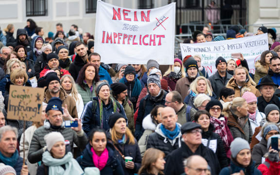 A demonstrator holds a placard reading 'No to compulsory vaccination' during an anti-vaccination protest at the Ballhausplatz in Vienna, Austria, on November 14, 2021.