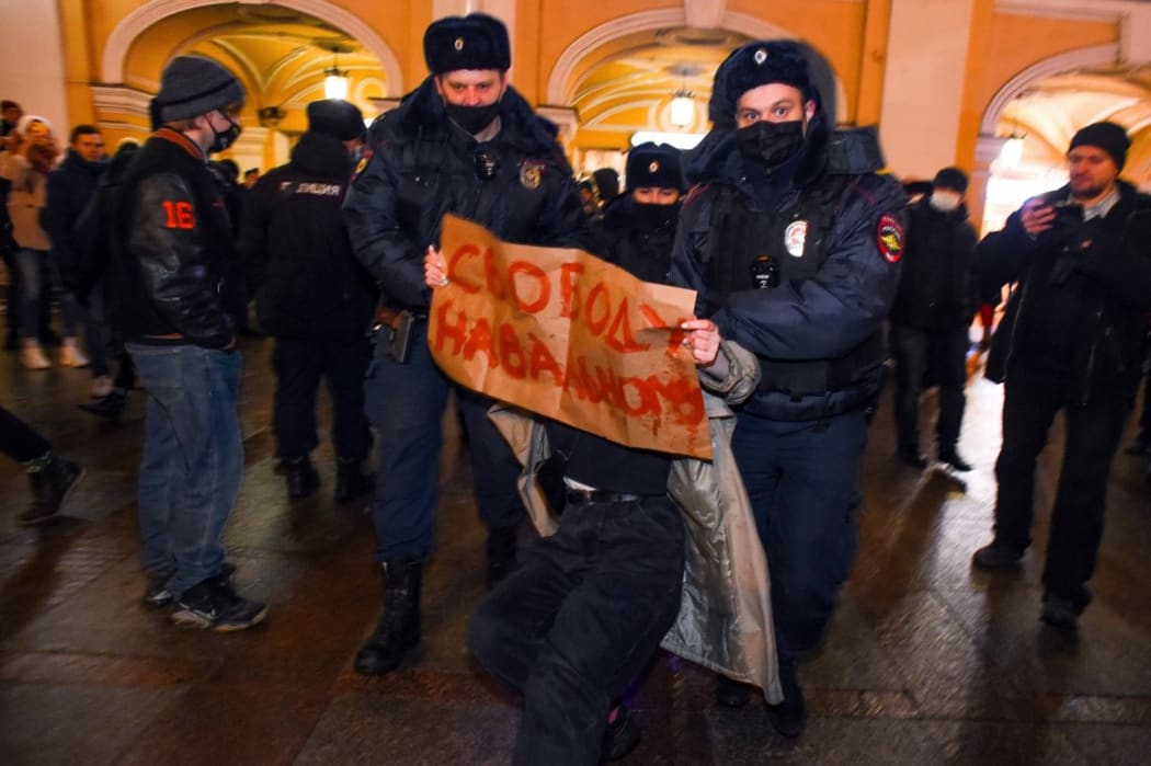 Police officers detain a supporter of Russian opposition leader Alexei Navalny in Saint Petersburg.