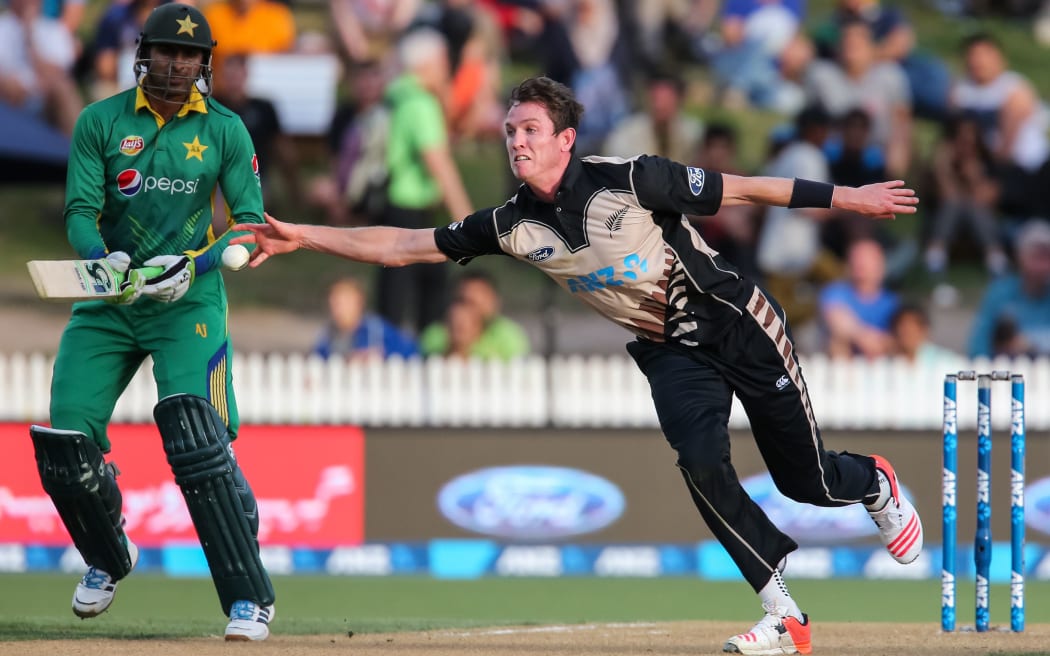 Adam Milne fields off his own bowling during the second T20 against Pakistan at Hamilton, January 2016.
