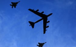 A US B-52 bomber is escorted by two F-15 fighter aircraft during a fly-over at a sports game in Louisiana, on 16 October 2021.