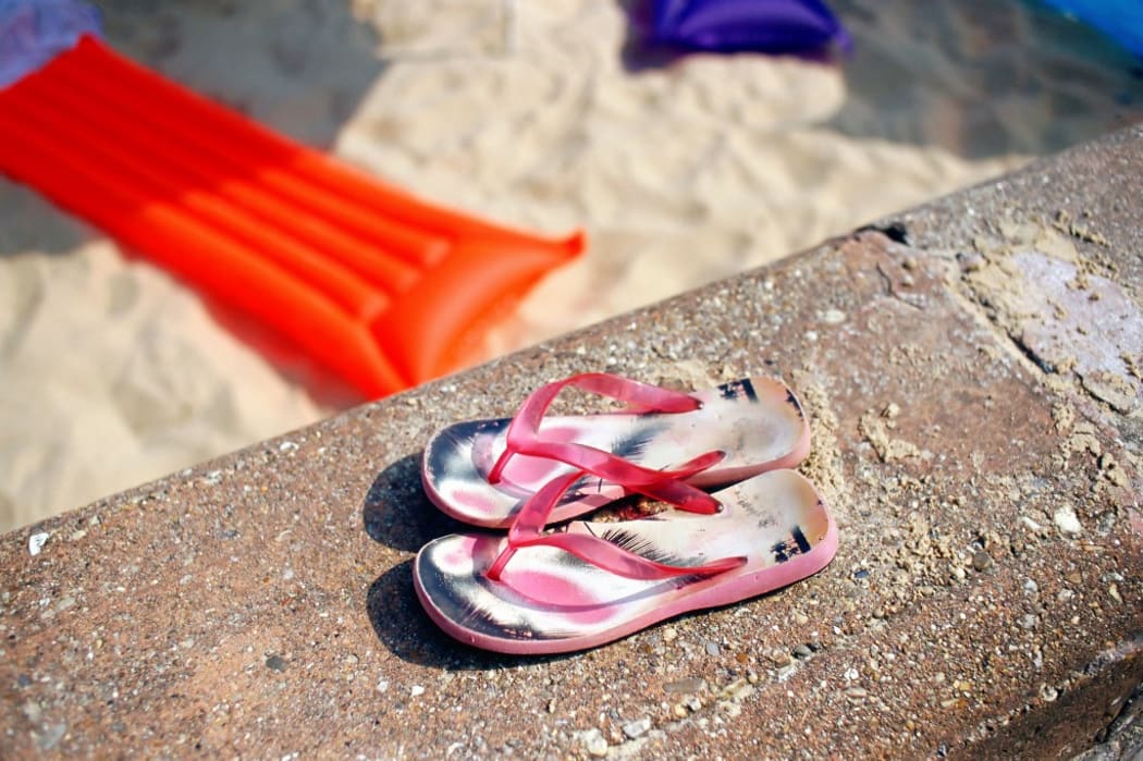 Flip-flops jandals thongs on the beach (Photo by SIMON POTTER / Image Source / Image Source via AFP)
