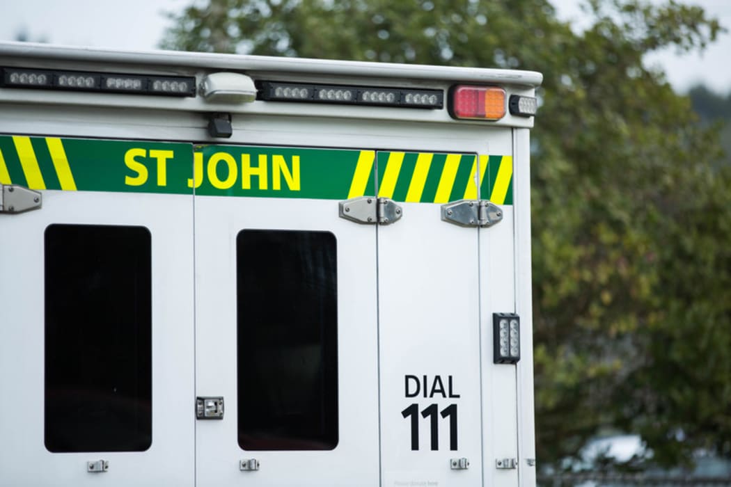 Close up of a St John ambulance on a residential street.