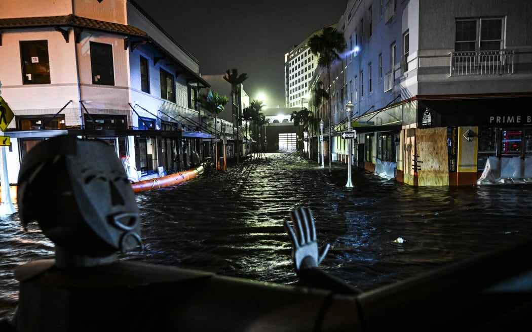 Water-flooded streets are seen after Hurricane Milton made landfall in Fort Myers, Florida, on October 9, 2024. - Milton made landfall in Florida October 9, 2024 as an "extremely dangerous" Category 3 hurricane, packing life-threatening storm surge, extreme winds and flash flooding, the National Hurricane Center (NHC) said. "Data indicate the eye of Hurricane Milton has made landfall near Siesta Key in Sarasota County along the west coast of Florida," the NHC said in an 8:30 pm (0030 GMT Thursday) bulletin. (Photo by CHANDAN KHANNA / AFP)