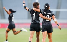 Ruby Tui and Stacey Fluhler celebrate winning Olympic gold in Tokyo.