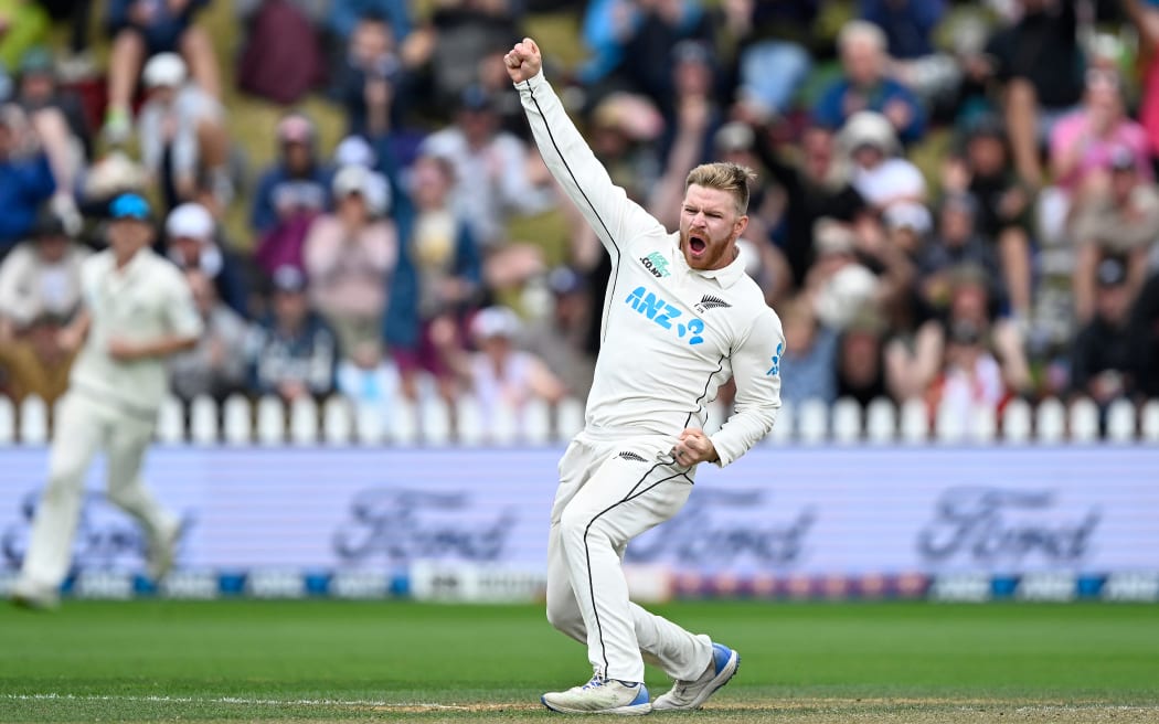 Glenn Phillips celebrates the wicket of Australia's Alex Carey.
