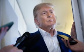 US President Donald Trump speaks to reporters about the Israel-Iran conflict, aboard Air Force One on June 24, 2025, while traveling to attend the NATO's Heads of State and Government summit in The Hague in the Netherlands.