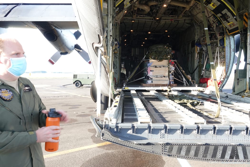 Tim Leslie prepares for a flight, with the supplies to be dropped in the aircraft.