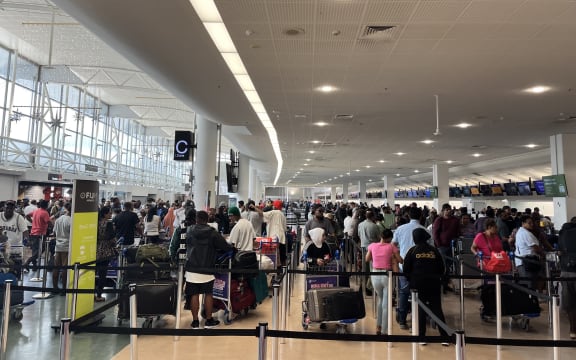 Crowds at Auckland Airport as travelers head away for Christmas 2024.