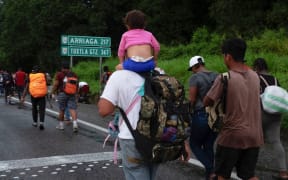 Central American and Haitian migrants are seen heading in a caravan to the US, in Huixtla, Chiapas State, Mexico, on September 4, 2021.