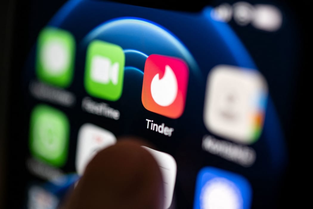 PRODUCTION - 02 September 2022, Baden-Wuerttemberg, Stuttgart: ILLUSTRATION - A hand taps on the Tinder app installed on a smartphone. The dating app launched on September 12, ten years ago. (to dpa-Korr "10 years of Tinder: A decade of dating in a new dimension") Photo: Marijan Murat/dpa (Photo by MARIJAN MURAT / DPA / dpa Picture-Alliance via AFP)