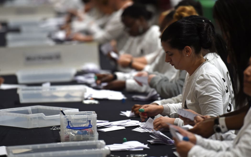 Ballot papers are sorted at the counting centre at Alexandra Palace in London
