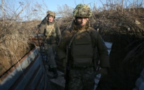 Ukrainian Territorial Defense Forces, the military reserve of the Ukrainian Armes Forces walk on a trench on the frontline facing Russia-backed separatists near to Avdiivka, southeastern Ukraine, on Saturday.
