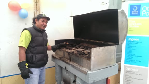 John Eteuati with his clean-burning umu.