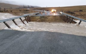 Floodwater washed away a bridge on Lake Ōhau Road, near State Highway 8, cutting off access to the Lake Ōhau township.